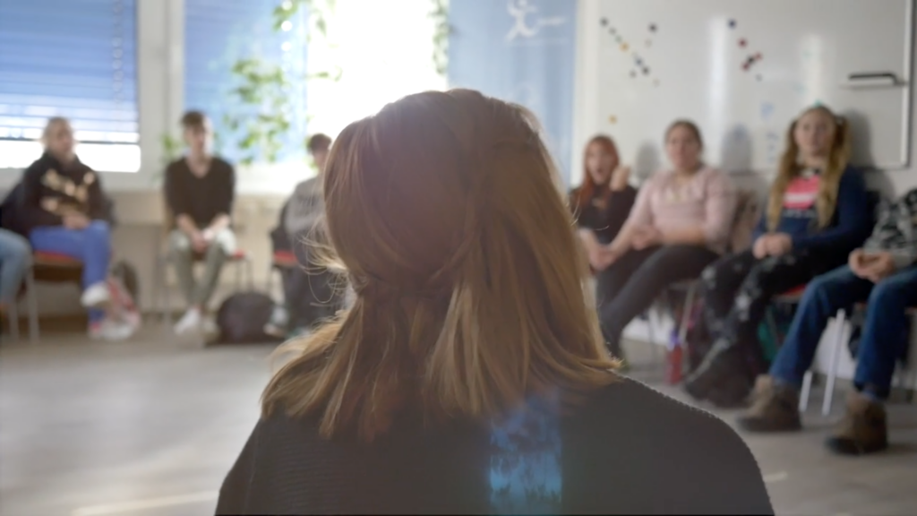 Teamerin -von hinten- Schulklasse im Hintergrund